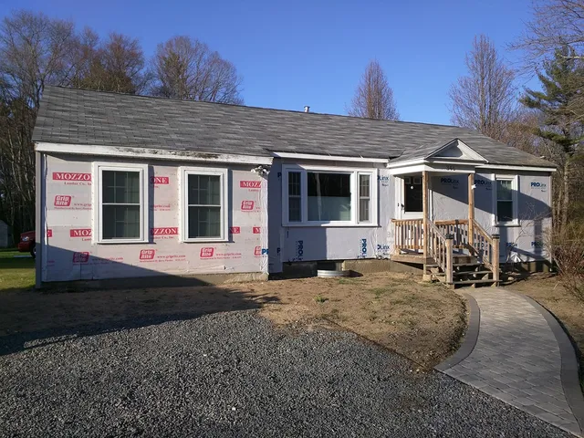 Ranch home wrapped in house wrap before new siding