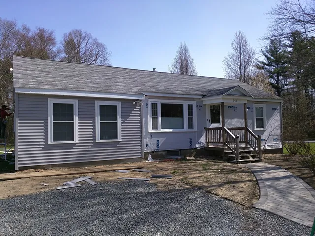 Ranch home finished with new gray vinyl siding