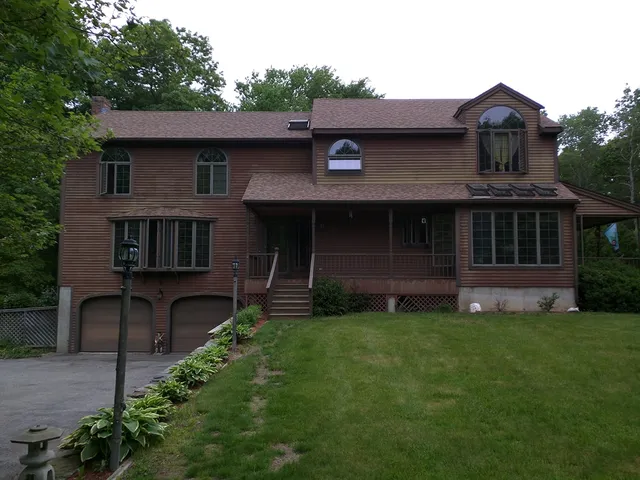Brown two-story home with an attached garage