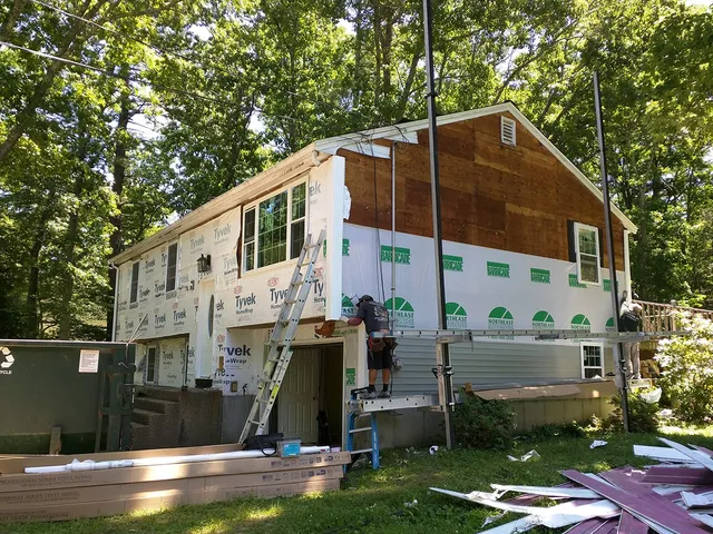 Home partly covered in new house wrap and siding