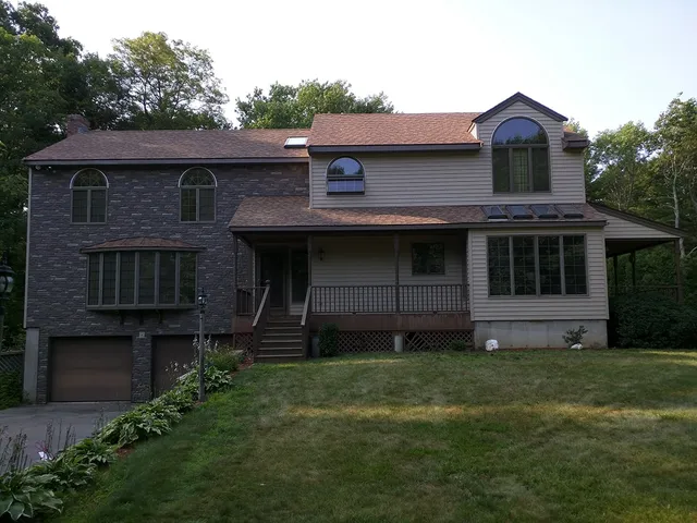 Two-story home with stone accents and new siding
