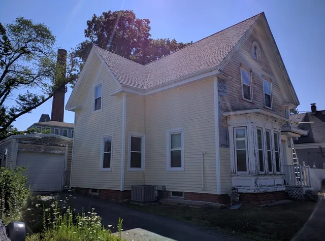 Cream-colored home with freshly installed siding
