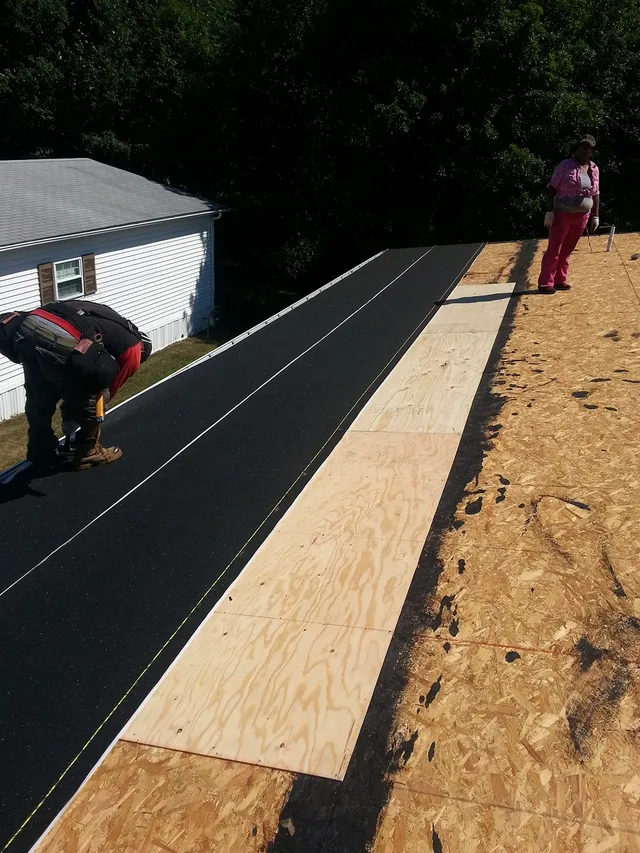 Roof deck with new underlayment being laid