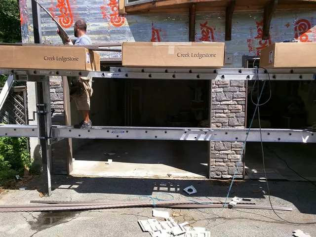 Garage wall with stone veneer under construction