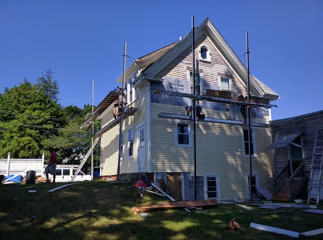 Home with scaffolding as new siding goes on