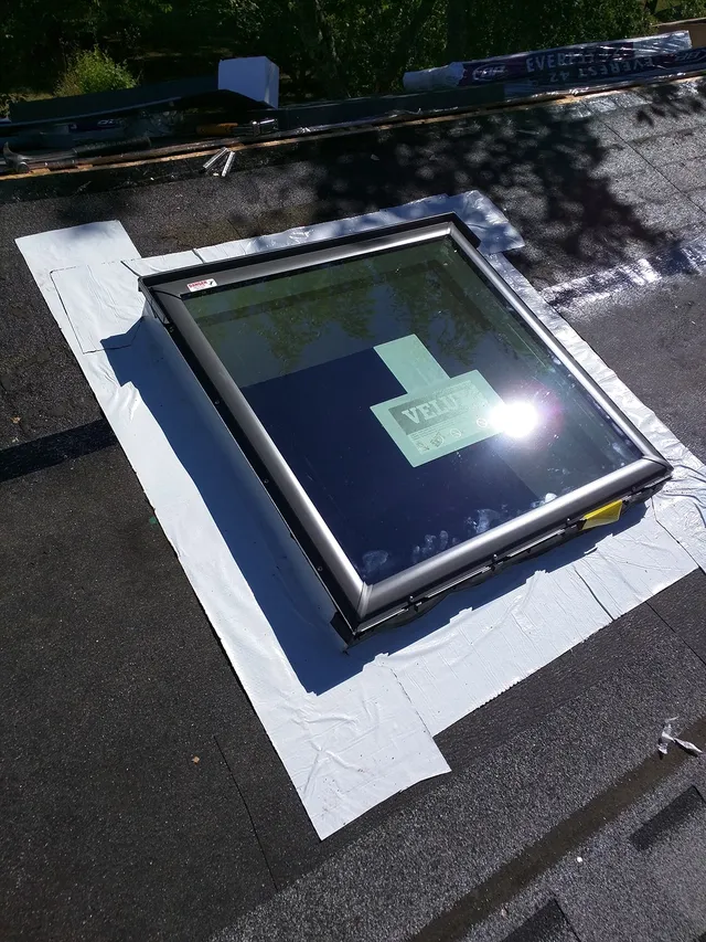 New skylight flashed into a shingled roof