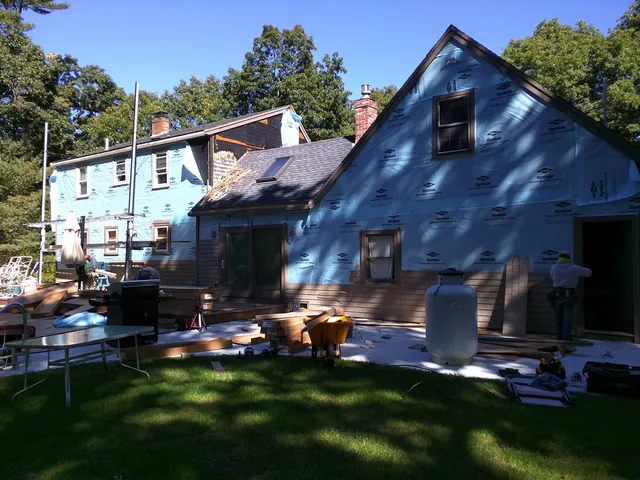 Home midway through a color change to new blue-gray siding