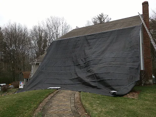 Old roof stripped and covered with tarps
